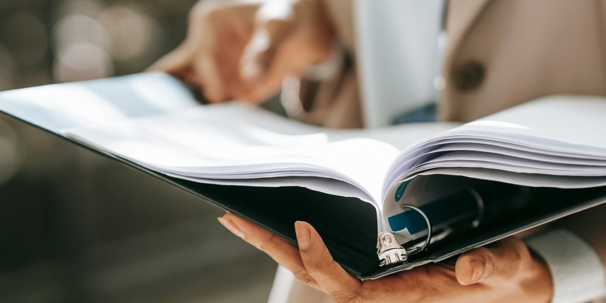 A person carefully reviewing documents, symbolizing attention to serious risks and making informed health decisions.