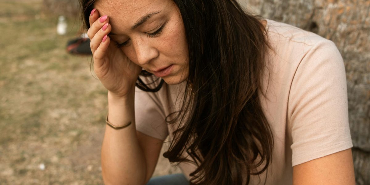 A person experiencing feelings of sudden fear and physical discomfort, indicative of a panic attack.