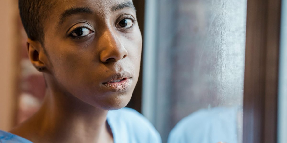 A person calmly looking at information, perhaps researching or reflecting on medication side effects and their management.