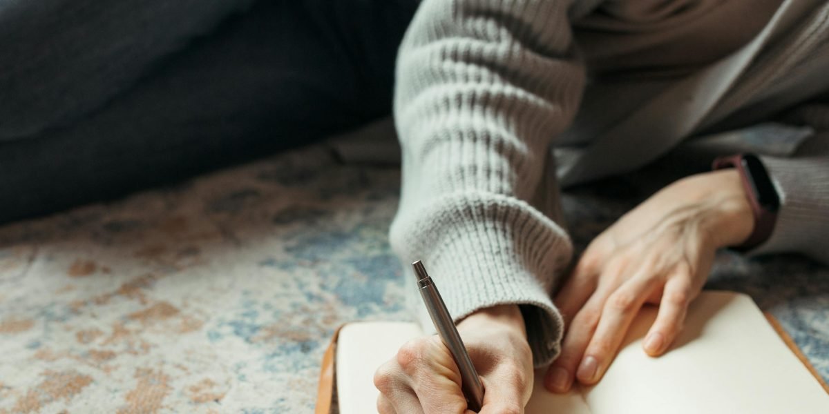 A person engaging in journaling as a coping strategy to process thoughts and reality-test suspicions.