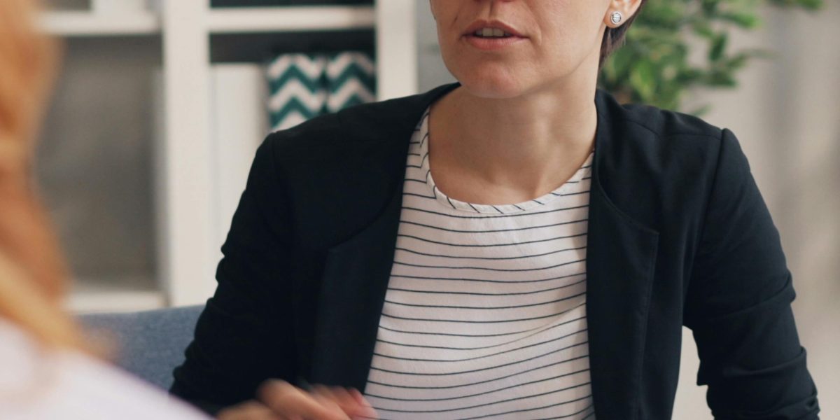 A therapist and patient engaged in a supportive and focused conversation during a psychotherapy session.