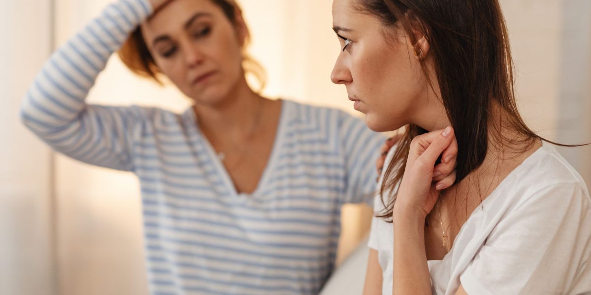 Friends or family members engaging in a supportive conversation, subtly hinting at concern for a loved one's well-being or living situation.