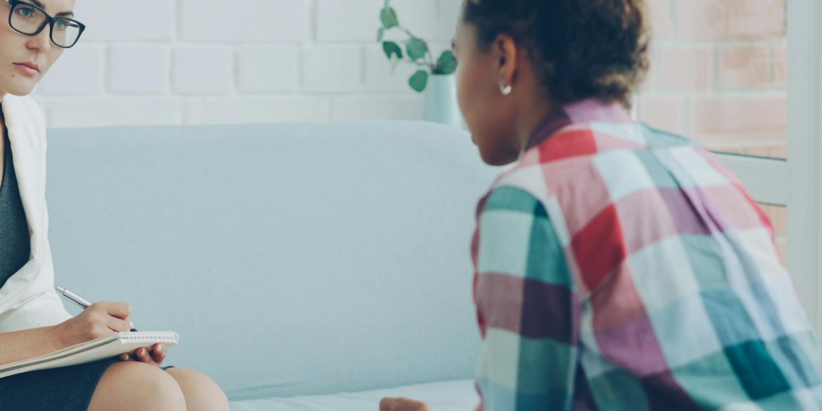 A person actively engaging in a discussion with a mental health professional, seeking expert diagnosis and guidance.