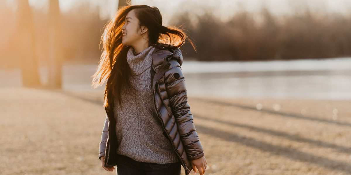 A person enjoying a peaceful walk in a natural setting, illustrating the calming effect of physical activity.