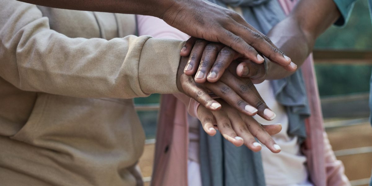 A diverse group of individuals in a supportive setting, emphasizing the importance of community in managing mental health.
