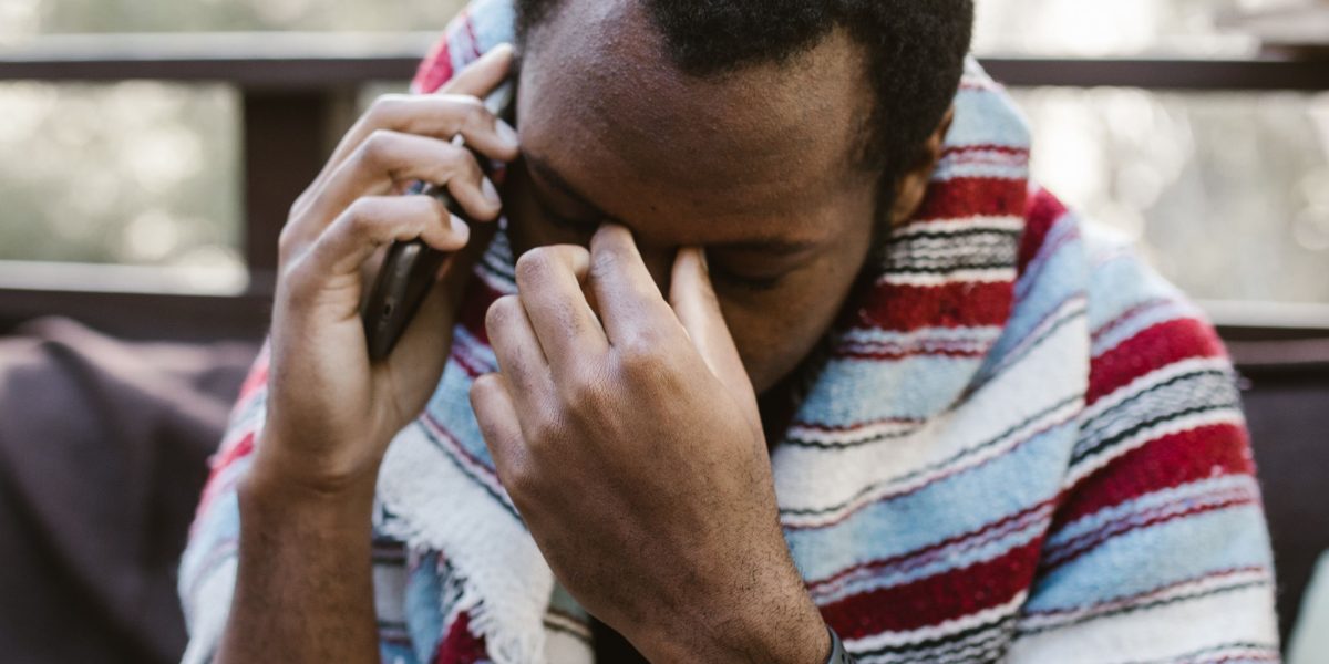 A person looking apprehensive in a social setting, reflecting the feelings of social anxiety disorder.