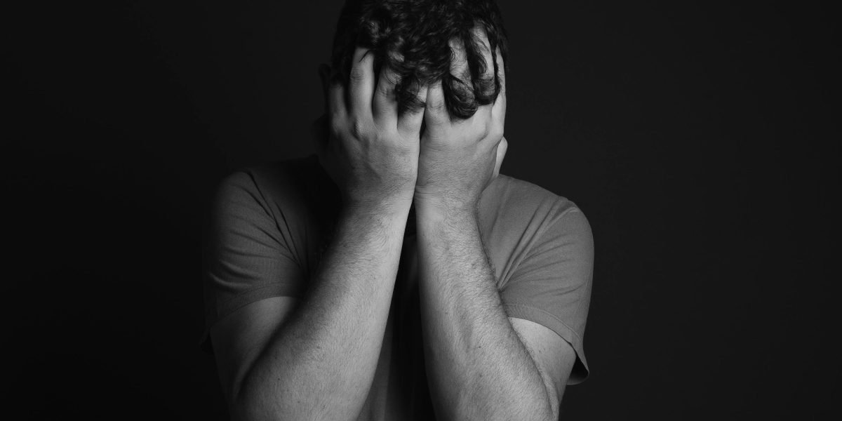 A person sitting alone, possibly indicating feelings of withdrawal or lack of motivation often associated with negative symptoms of schizophrenia.