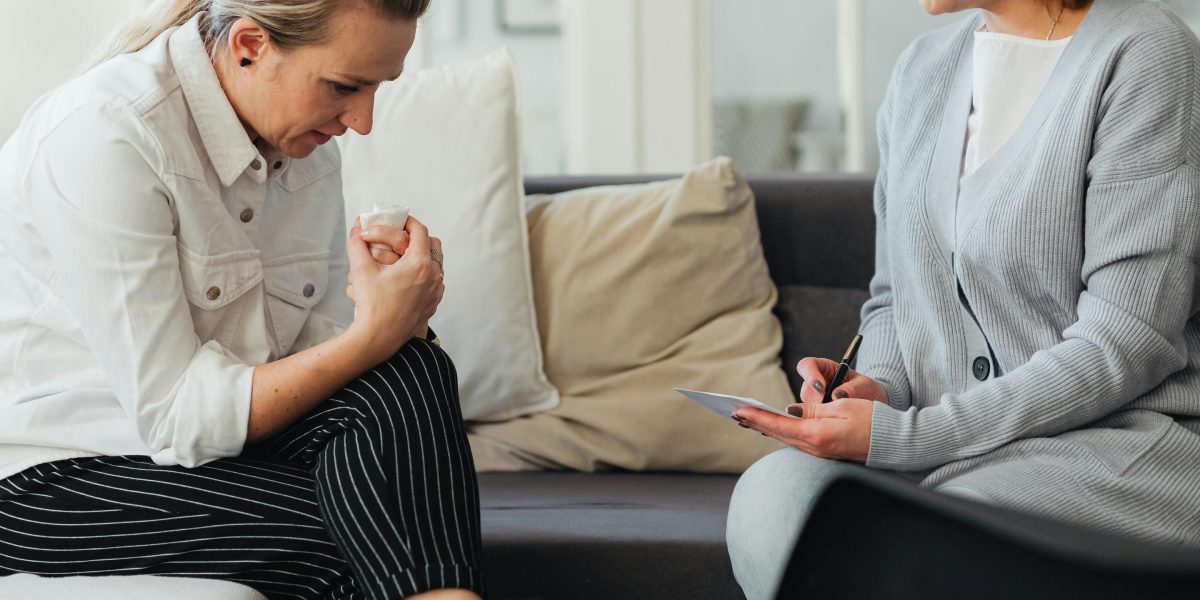 A person speaking to a mental health professional, illustrating the act of seeking help.
