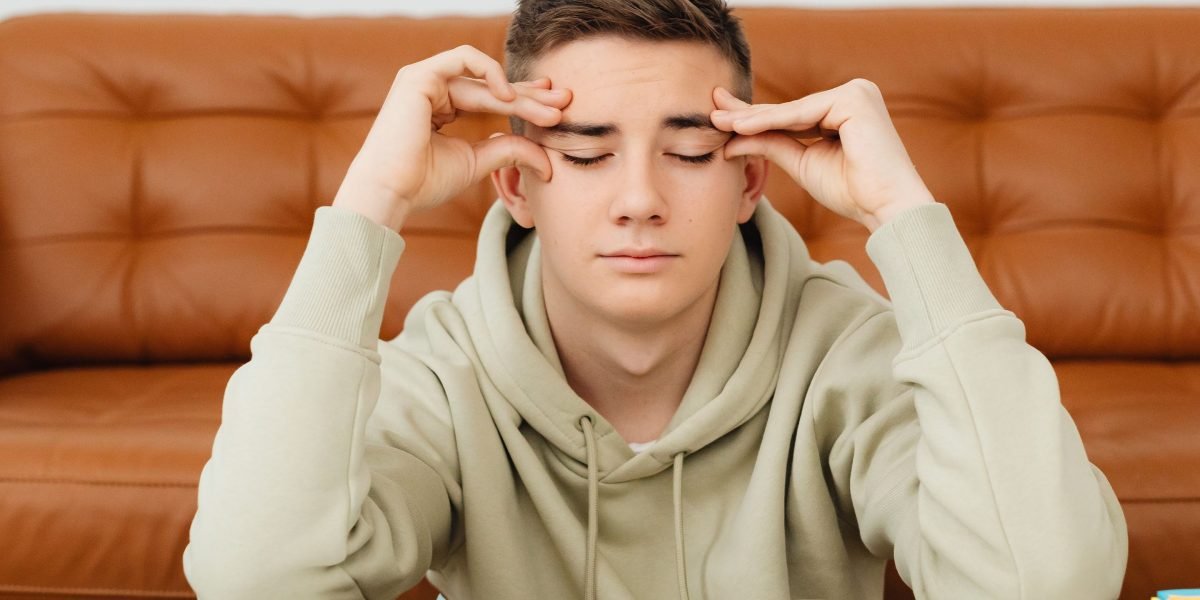 A teenager looking overwhelmed, reflecting the common visible signs of stress and anxiety.