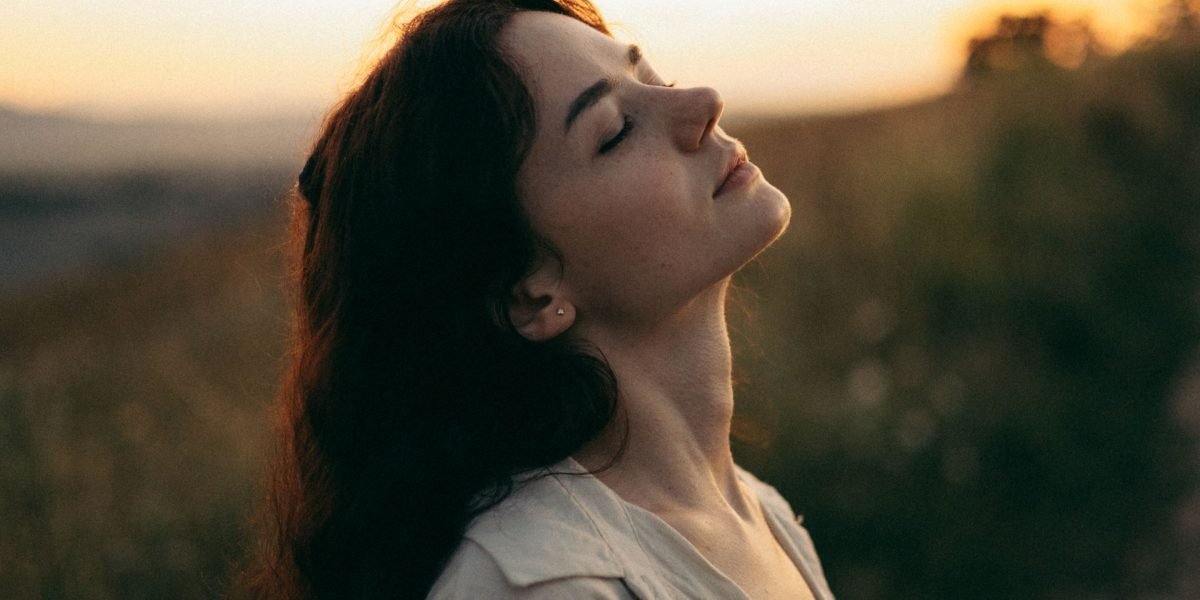 A person feeling calm and at peace, symbolizing the outcome of understanding and managing complex emotions.