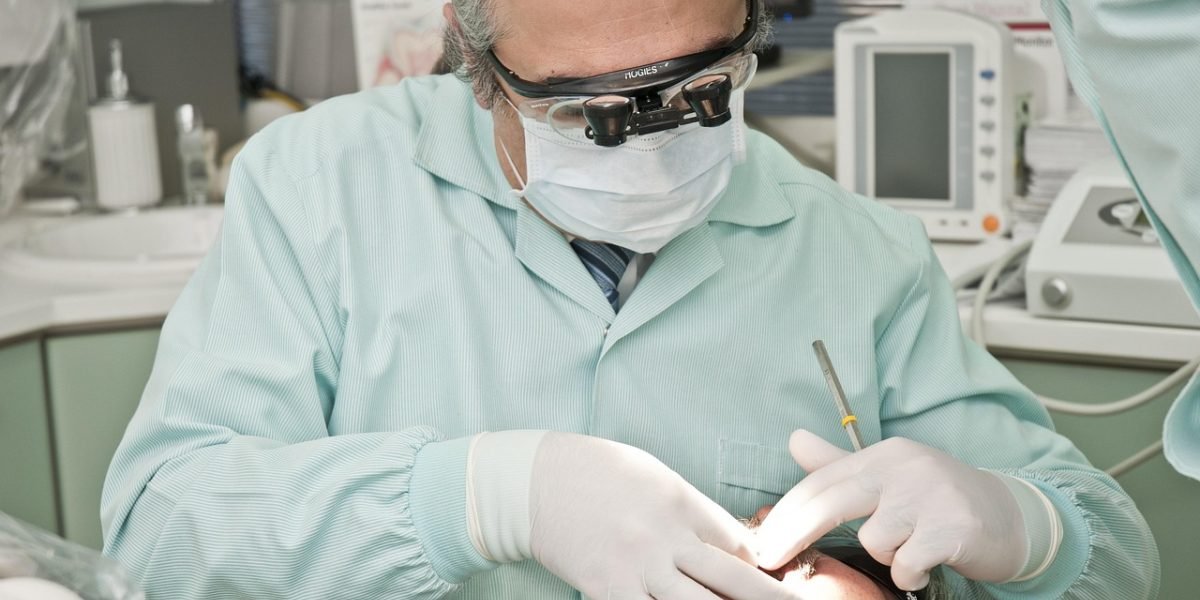 A doctor meticulously reviews a patient's health records during the safety screening process for ketamine treatment.