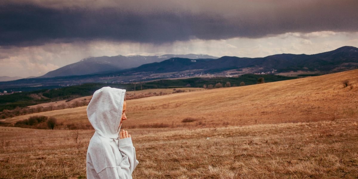 A person finding calm through meditation or mindfulness in a natural setting.