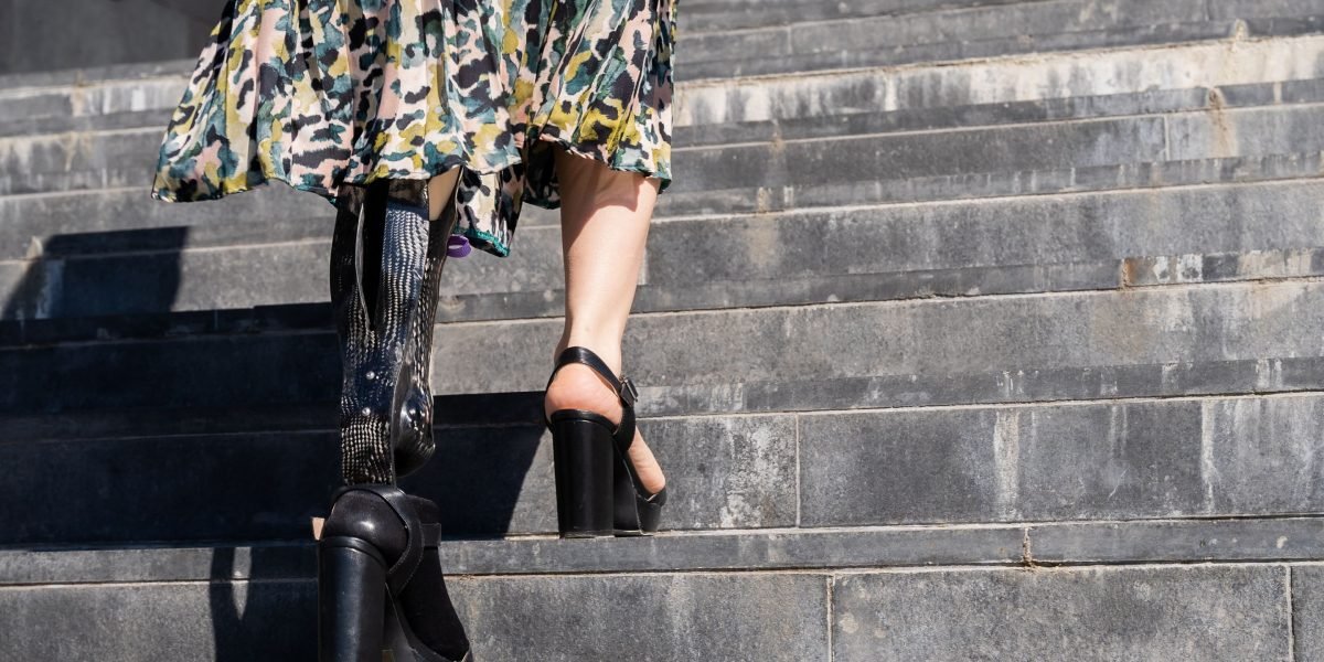 A person walking confidently on a path or road, representing the journey of recovery and moving forward after a crisis.