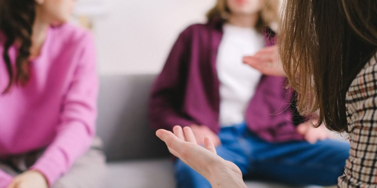Individuals engaging in a support group setting, emphasizing the importance of community and connection for mental wellness.