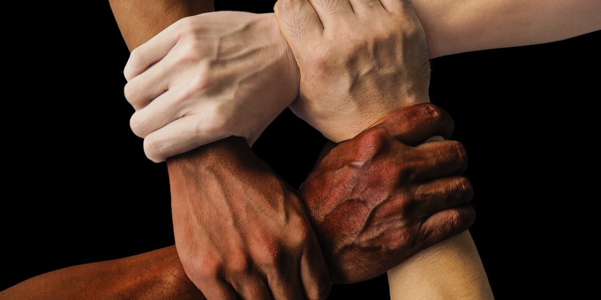 Diverse individuals connecting and supporting each other in a group setting, symbolizing community and shared experience in recovery.