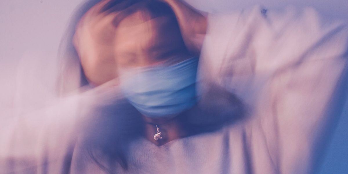 A person in a social setting experiences internal anxiety, reflecting the common struggle with social fear.