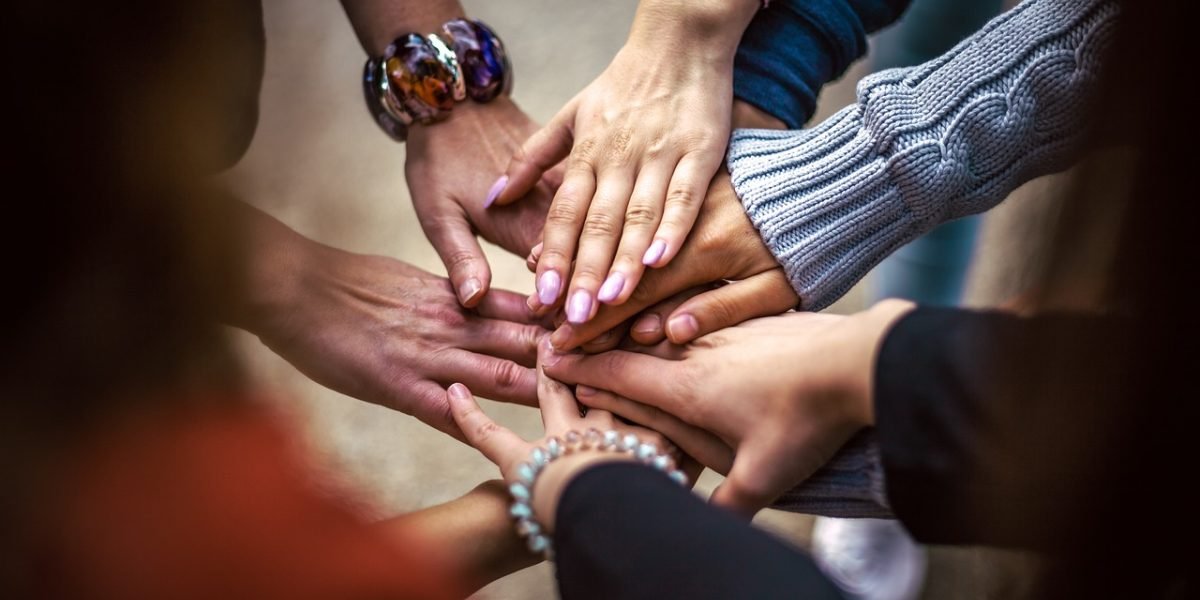 Individuals in a supportive group setting, emphasizing the importance of community and shared experience in coping.