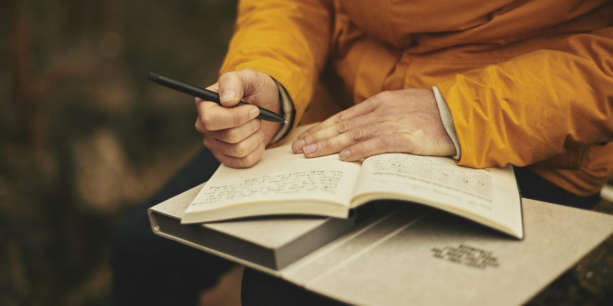 A person thoughtfully reads a document, symbolizing the act of seeking knowledge and understanding about health topics like NAC.