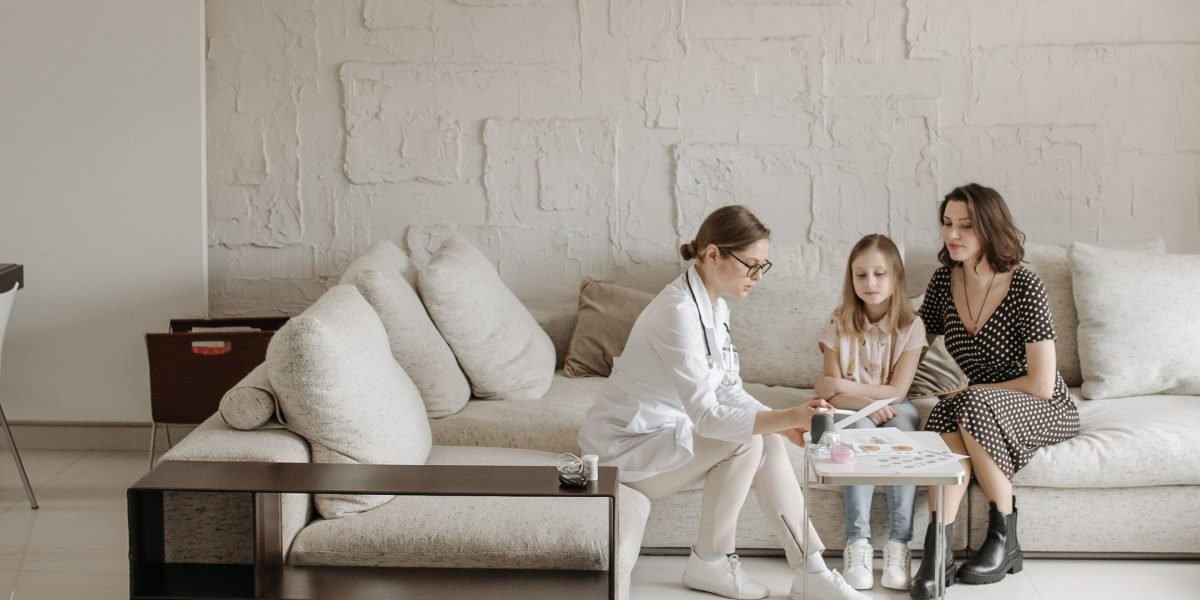 A family or caregiver consulting with a healthcare professional, representing special population care.